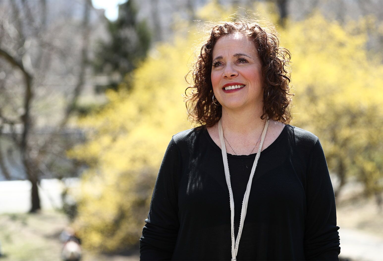 Woman in her 50s enjoys a sunny day.