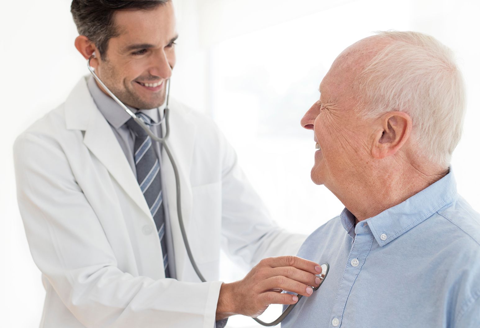 Male doctor examining senior patient