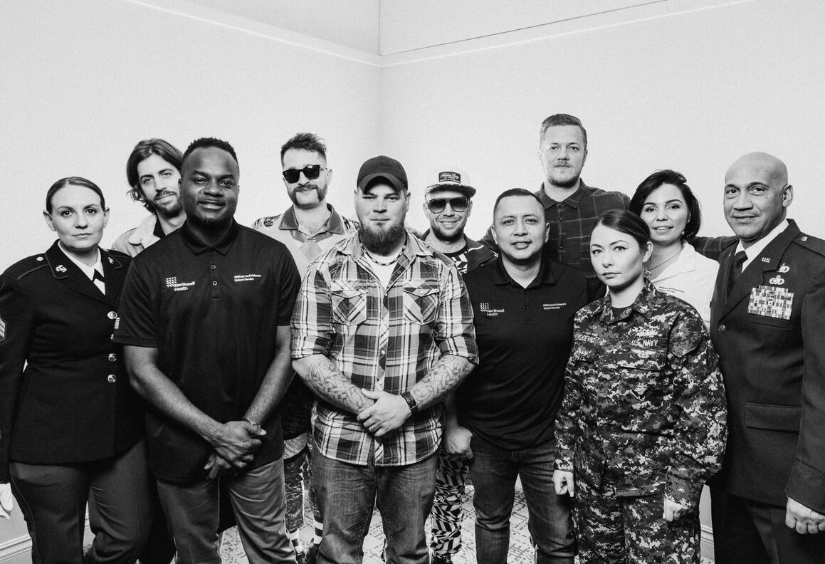 Members of Imagine Dragons with veterans and Northwell staff