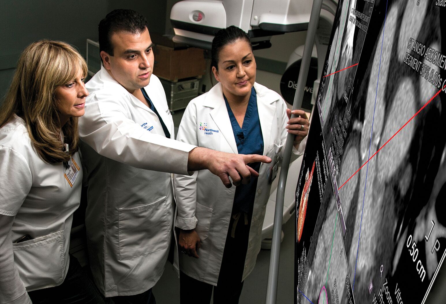 Dr. Gregory Maniatis (center) and members of the TAVR team review a case.