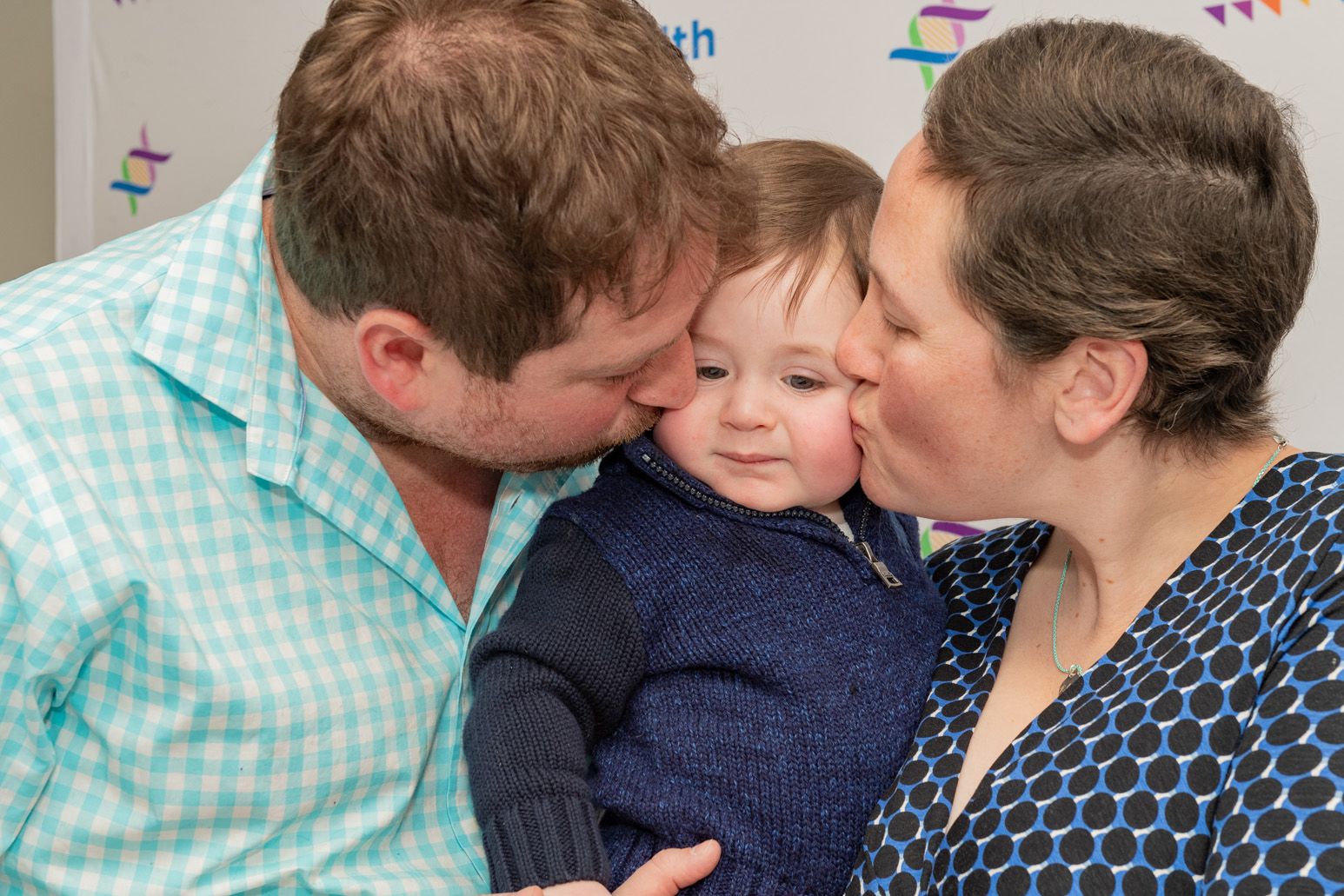 Josh and Michelle Cohen kiss baby Franklin