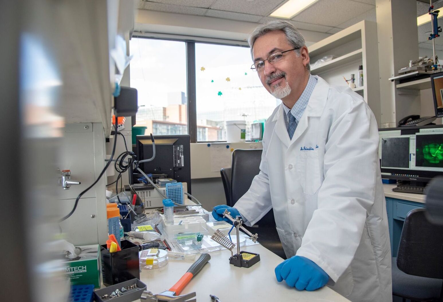 A researcher in the lab stopping for a photo.