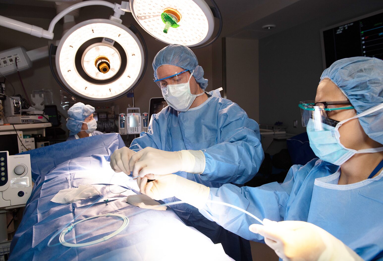 Dr. Chad Kliger and his surgical team in an operating room performing a cardiac catheterization