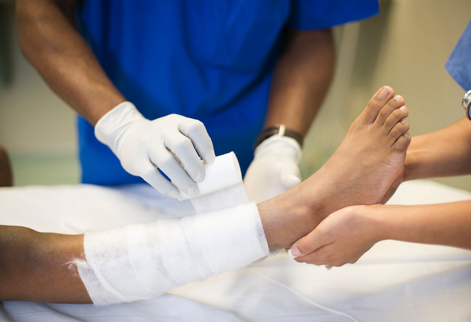 Doctor bandages patients ankle