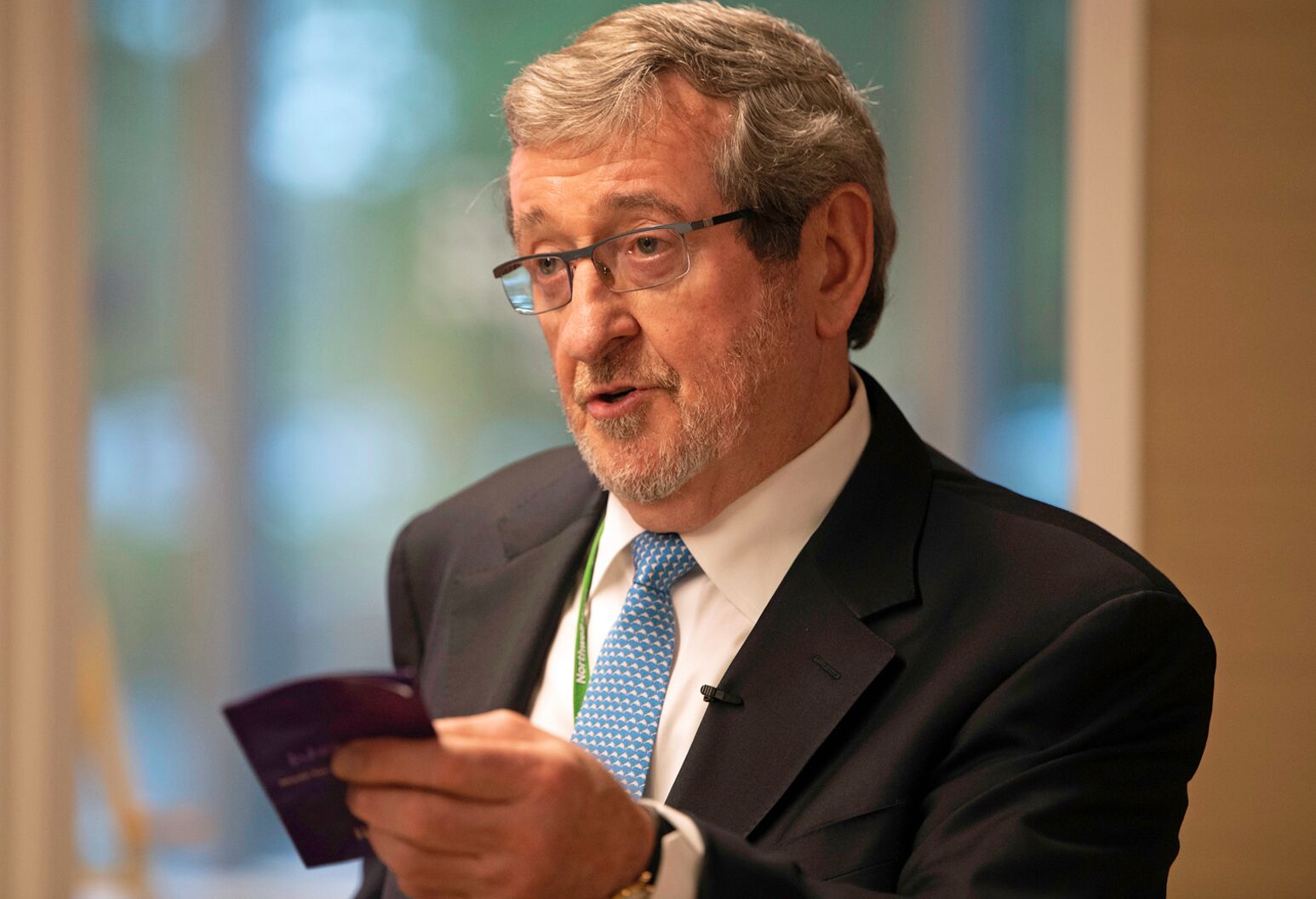 Michael Dowling holds a pamphlet while speaking at Northwell Health's Innovation Challenge