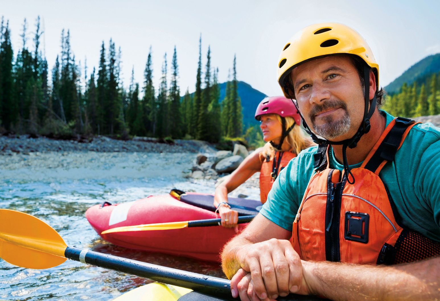 Portrait of confident man kayaking in river