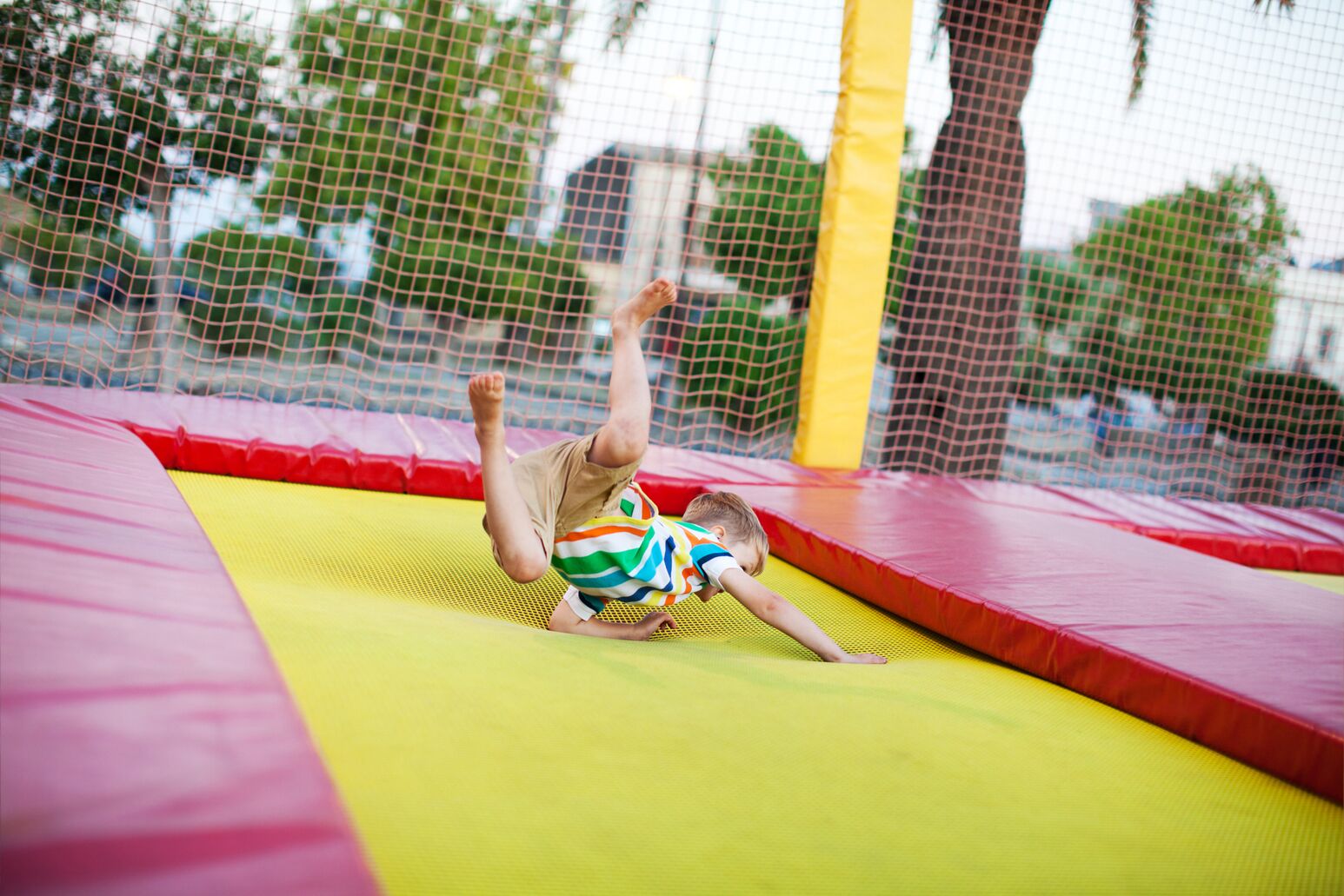 A child falls on a trampoline