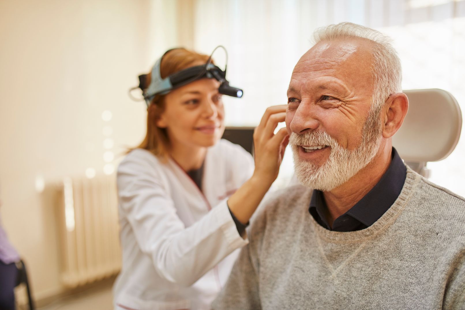 An ENT checks a man's ear