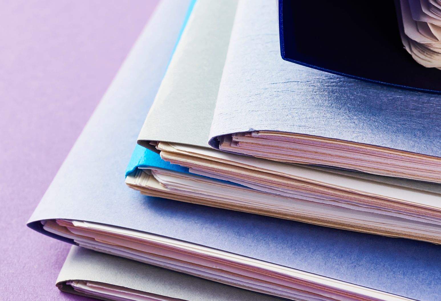 A desk with six folders filled with papers