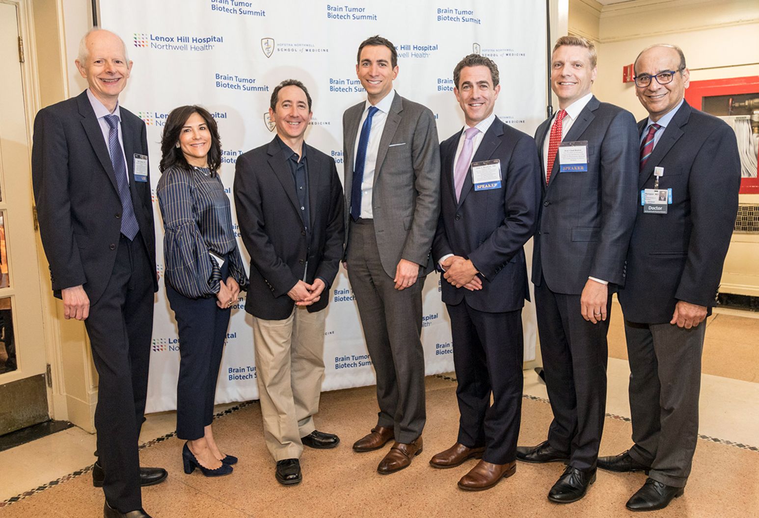 Group of 7 doctors stand together in a group photograph