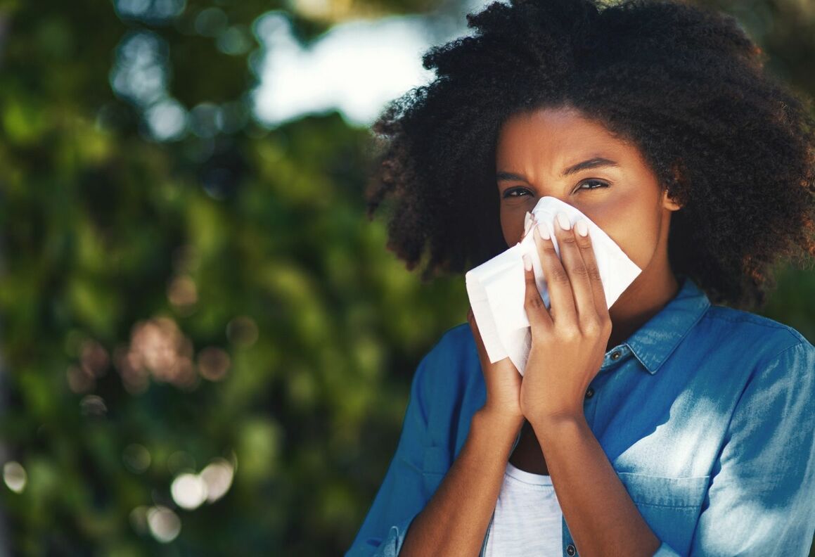 Woman using tissue outdoors