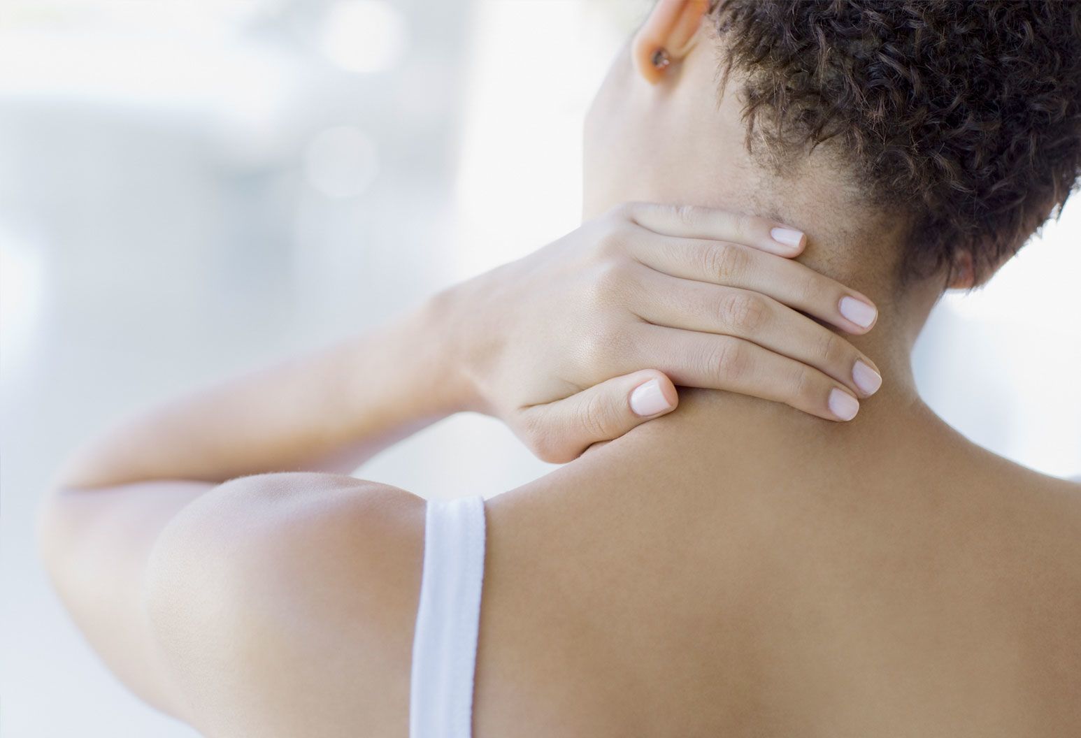 A Close Up View Of A Woman Holding The Back Of Her Neck And Tilting A Close Up View Of A Woman Holding The Back Of Her Neck And Tilting