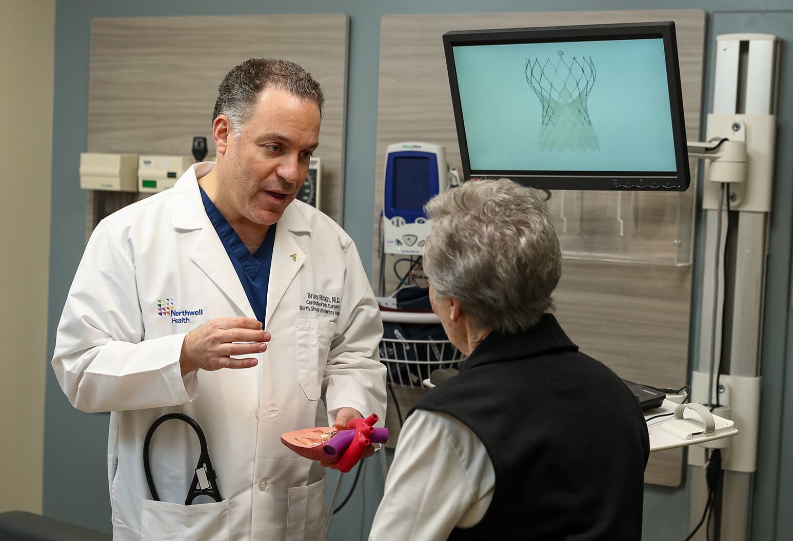 Interventional Cardiologist, Dr. Bruce Rutkin discussing TAVR surgery with an older female patient