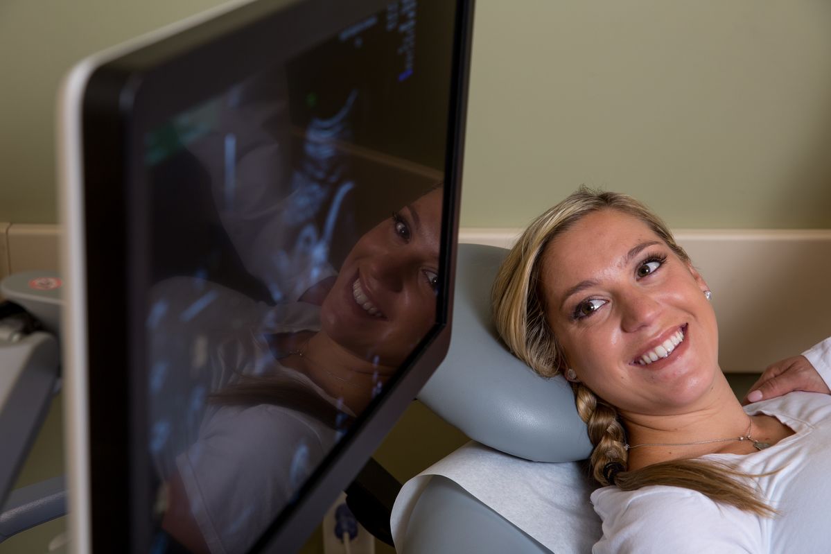 A pregnant woman checks her sonogram