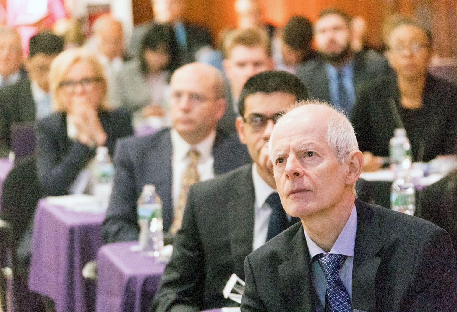 Group of professionals watch a presentation at a conference