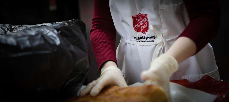 Thanksgiving Food Service Volunteers in Aprons Serving