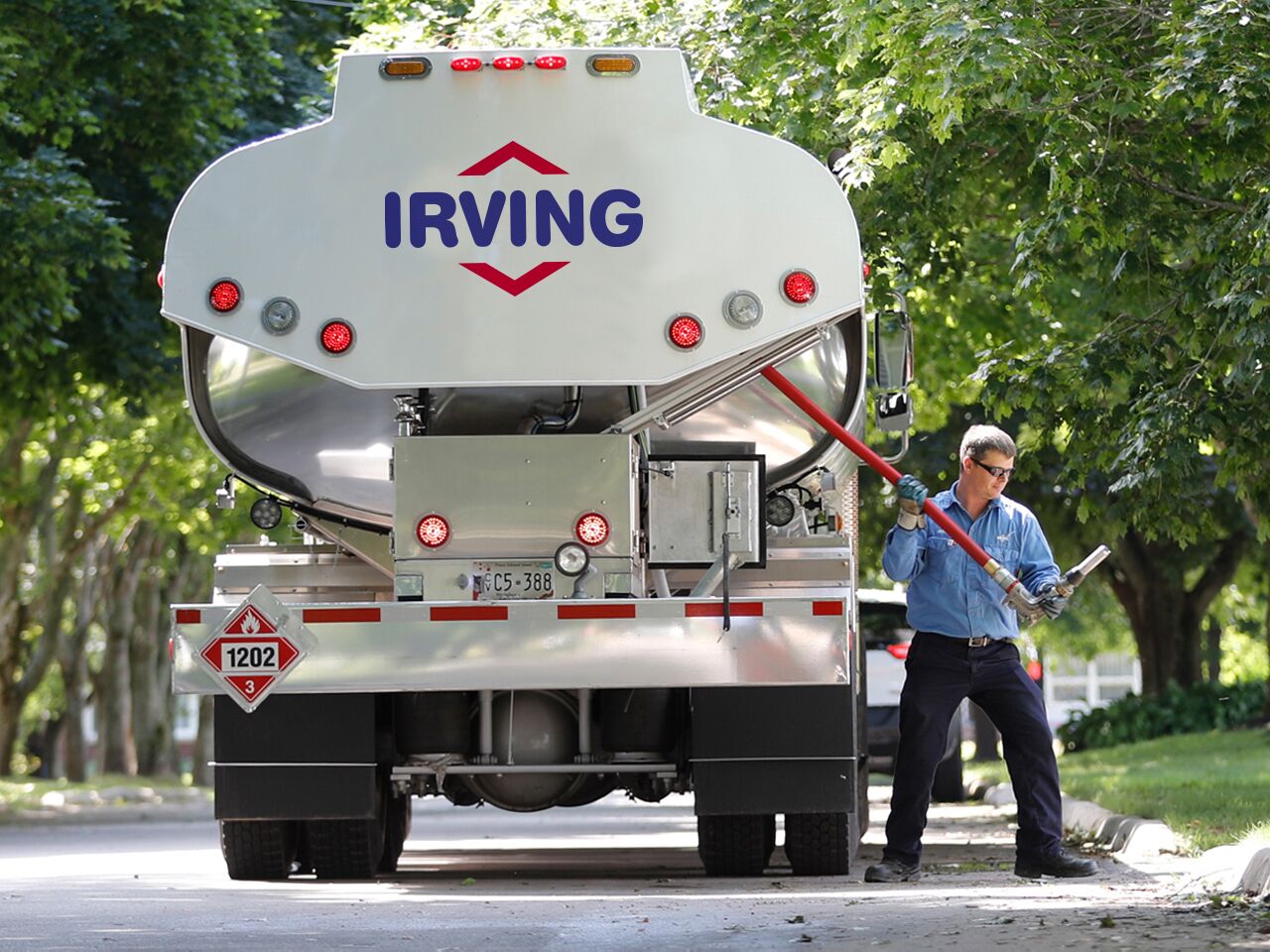 alt="operator unrolling hose from oil delivery truck" alt="operator unrolling hose from oil delivery truck"