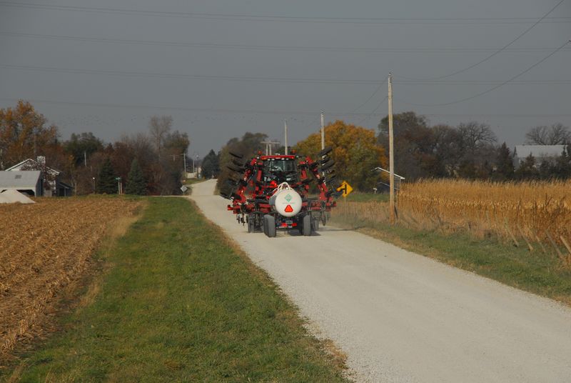 Farm equipment on a rural road during harvest. Farm equipment on rural road 11