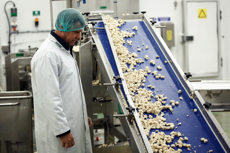 An employee inspects meat free 'chicken pieces' of Quorn, manufactured by Quorn Foods Ltd., as they travel along the production line at the company's factory in Stokesley, U.K., on Tuesday, Oct. 6, 2015. Britain's Quorn Foods is being acquired by Monde Nissin Corp. of the Philippines in a deal that values the 30-year-old meat-substitute maker at 550 million pounds ($833 million). Photographer: Simon Dawson/Bloomberg Fake Meat Chicken Factory