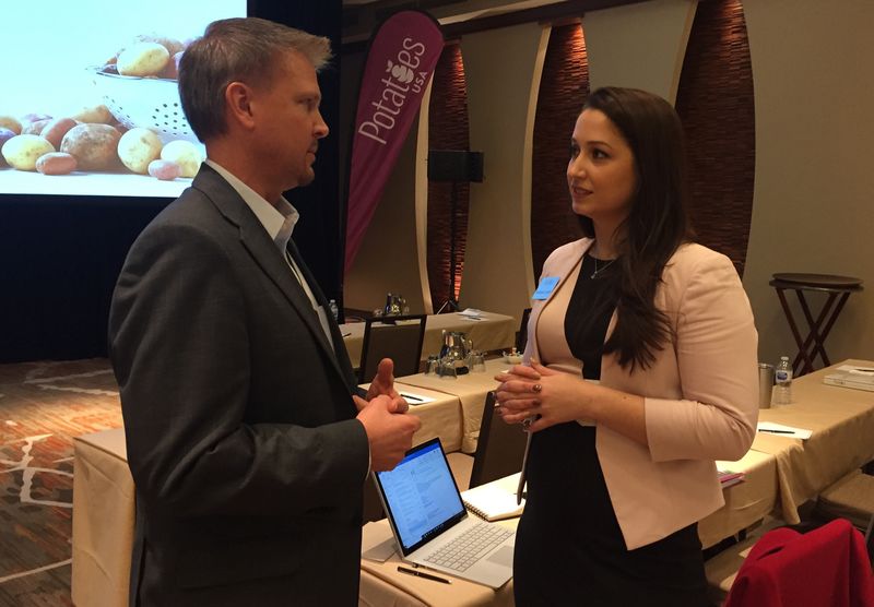 Mark Klompien, CEO of United Potato Growers of America, talks with Potatoes USA global marketing manager – school foodservice Rachael Lynch March 14 at the board’s annual meeting. usapotato3